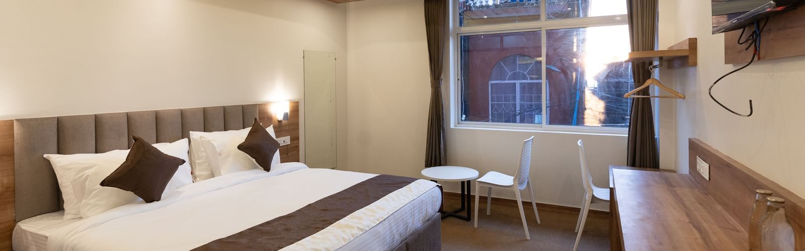 image of the standard room with a window in the corner at The Soma Hotel by Avianna Group, Darjeeling