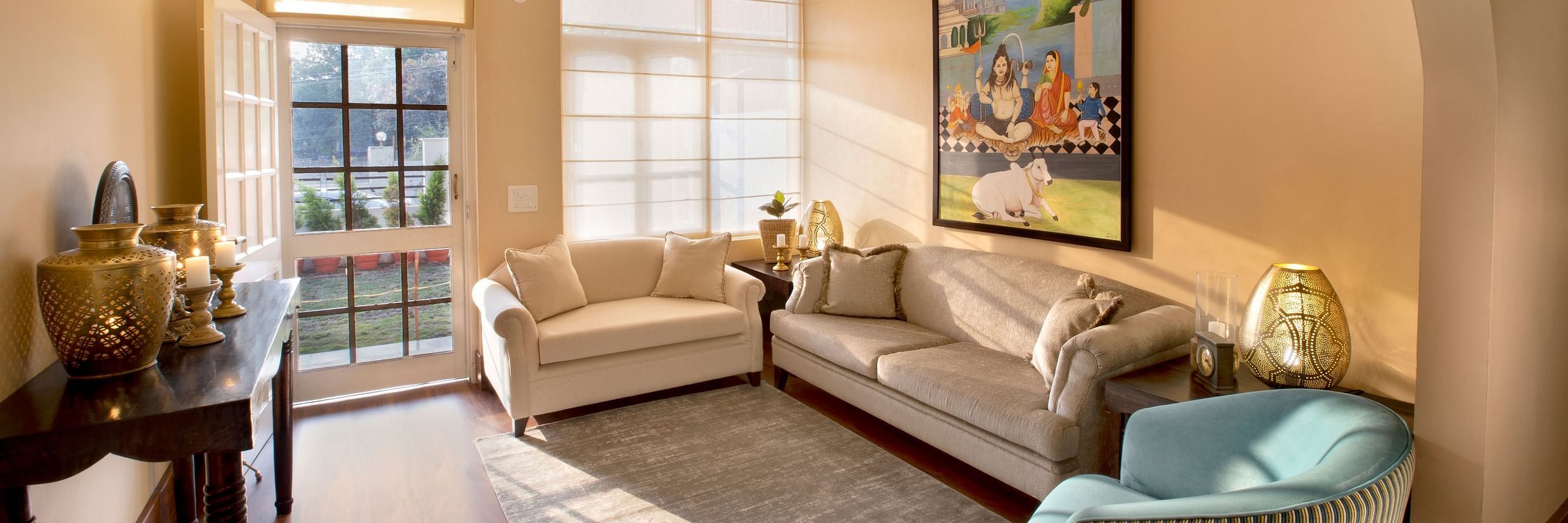 An image of a living room features comfy sofas and large windows 4 - Lamrin Boutique Cottages Rishikesh