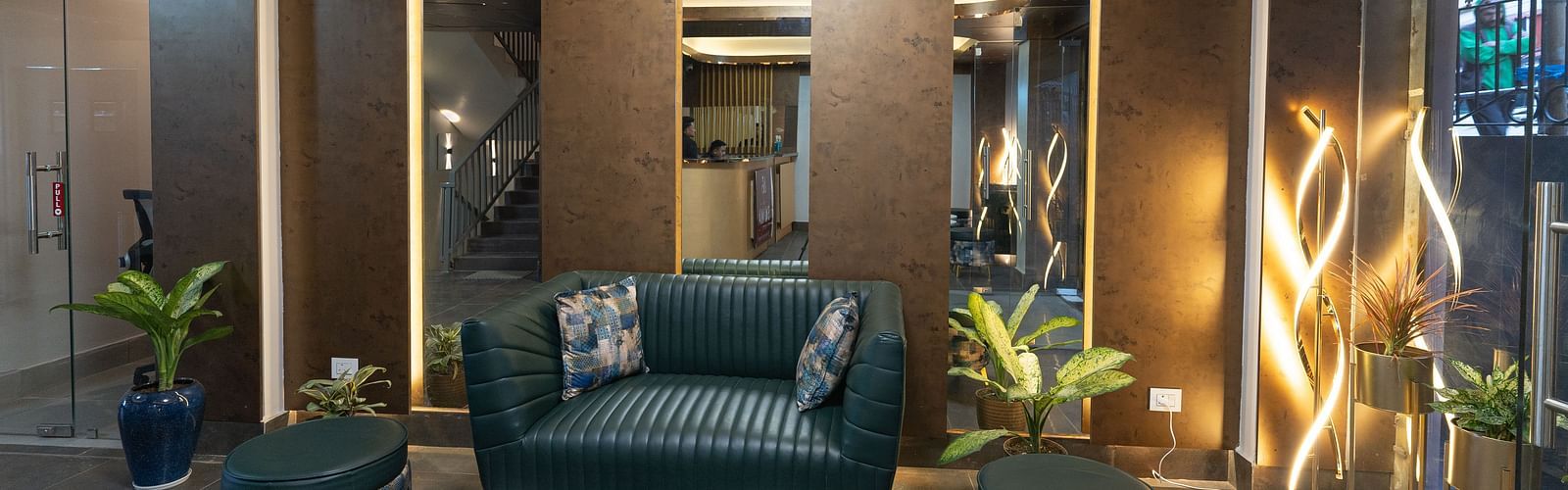 image of the lobby with teal coloured sofa set at The Soma Hotel by Avianna Group, Darjeeling