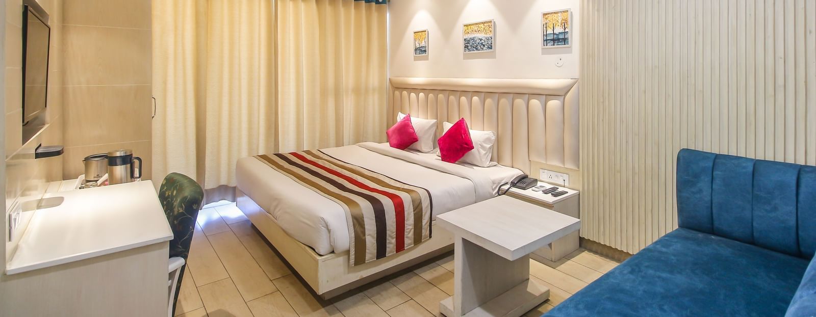 Spacious double room with bed and sofa at Hotel Diamond Plaza, Chandigarh
