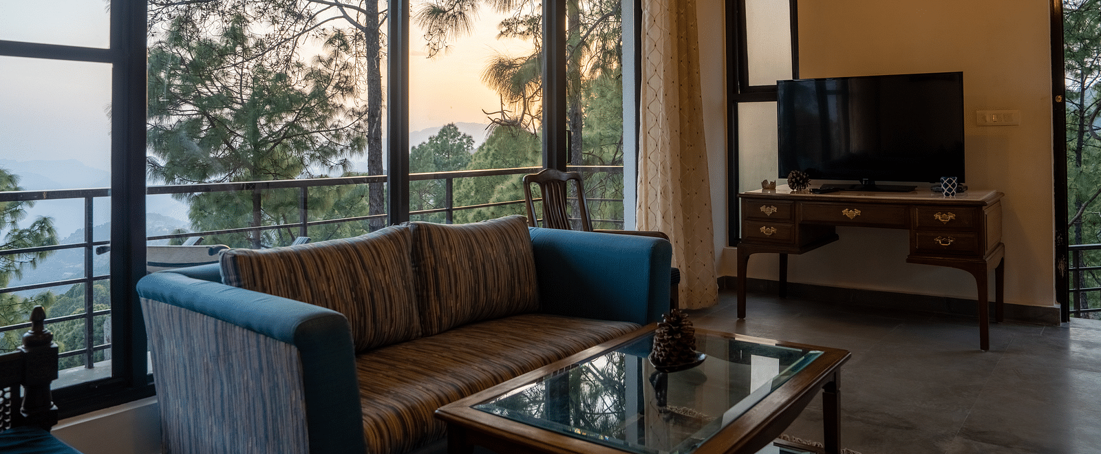 A suite living room with a television placed on the table at BluSalzz Escapade Resort, Lansdowne.