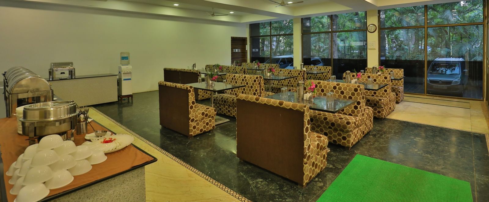 A large dining area with various seating areas, including sofas and low tables, and warm lighting - Retreat Heritage, Lonavala