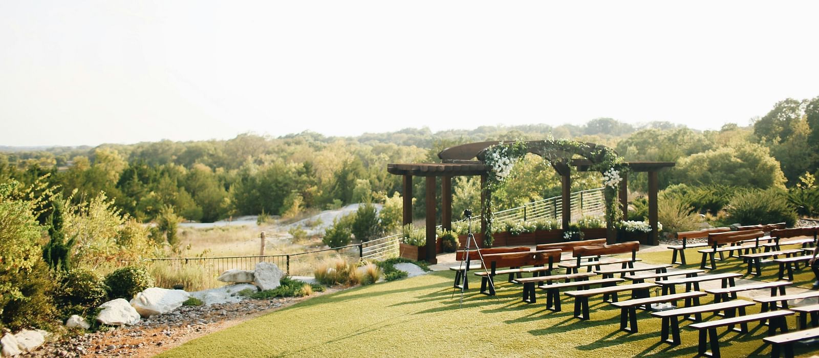 An aerial long shot of the wedding lawn, beautifully blanketed in lush greenery