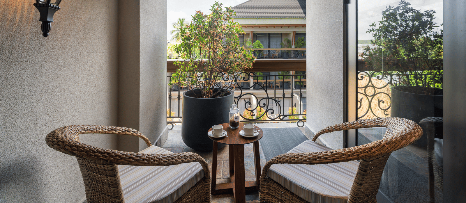2 arm chairs kept on the balcony of the Executive Room along with a small coffee table at The Evren, Vagator.