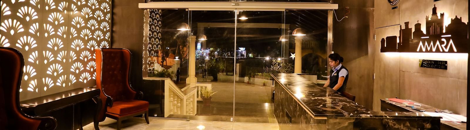 Image of a reception area with a seating area on the side and a reception table opposite it at Calux Grand Baga.