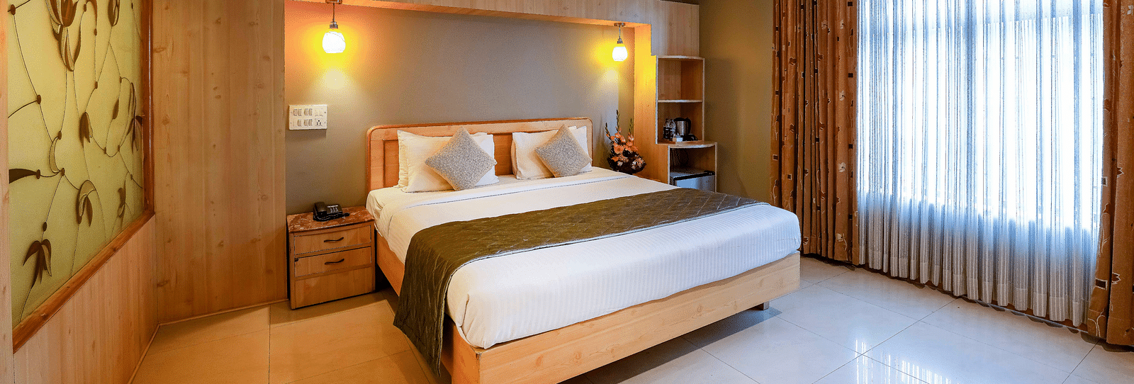 A bright Suite in Bangalore featuring a comfortable king size bed and elegant decor - Cross Roads Inn, Bengaluru