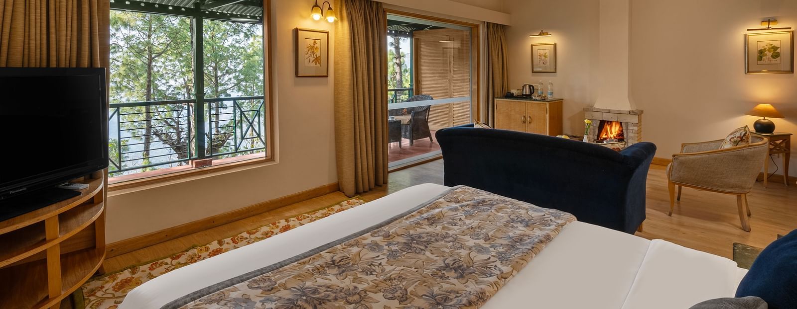 A premium cottage room featuring a cosy bed, open windows, and wall light fixtures that create a warm ambience -  Baikunth resort, kasauli 