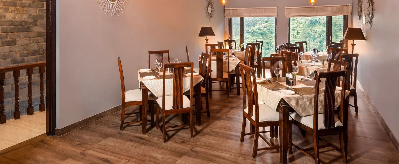 Rustic indoor dining area with wooden furniture and sloped ceiling, at BluSalzz Collection - Suvaasa Resort, Ramgarh.