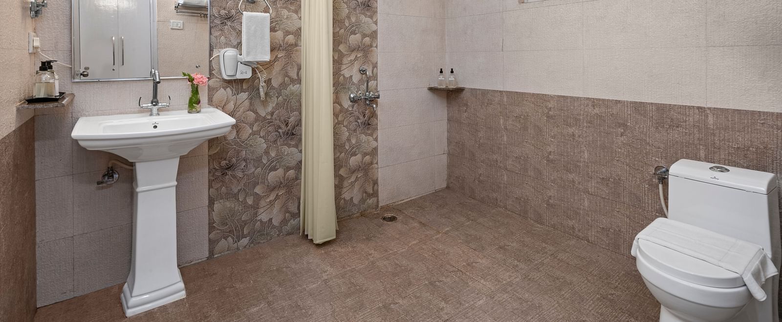 Spacious bathroom with essential amenities and natural lighting at BluSalzz Collection - Suvaasa Resort, Ramgarh.