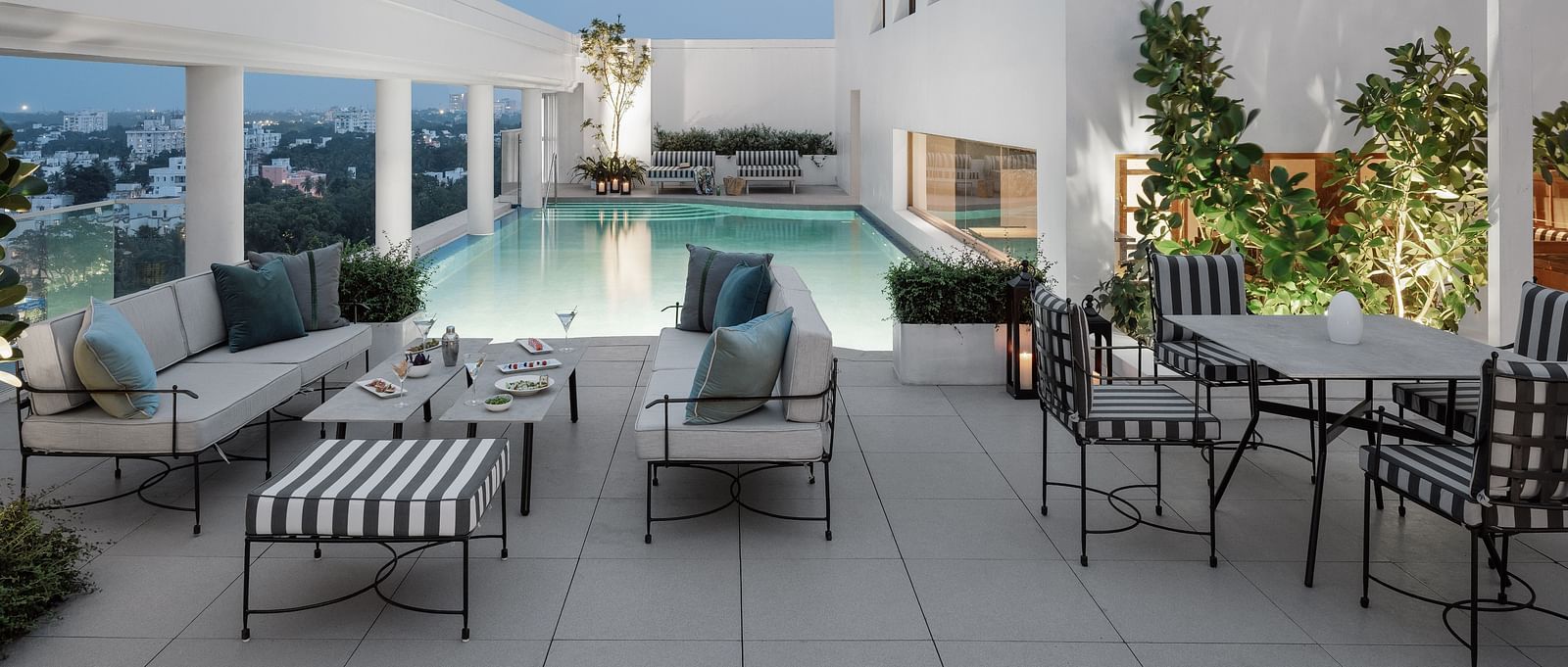 Image of a Swimming pool  with chairs and tables on the side at The Raintree St.. Mary s Road