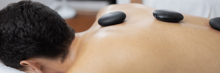 A person receiving hot stone therapy at the Spa at The Soco House.