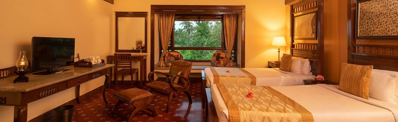 image of a twin bedroom of the heritage premium cottage featuring a brightly lit room at hoysala village resort