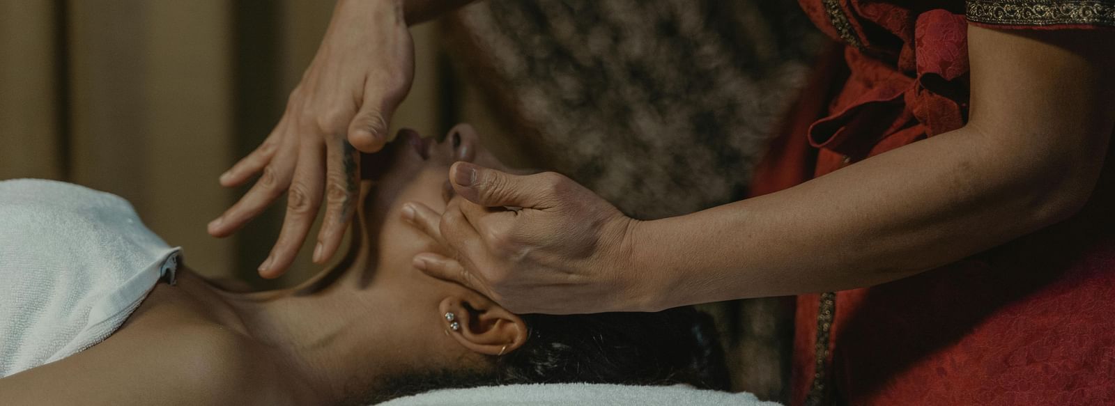 A masseuse providing a face massage