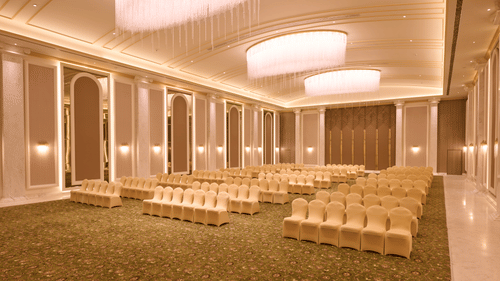 Banquet hall with rows of chairs set facing forward at Sarovar Premiere Amritsar.