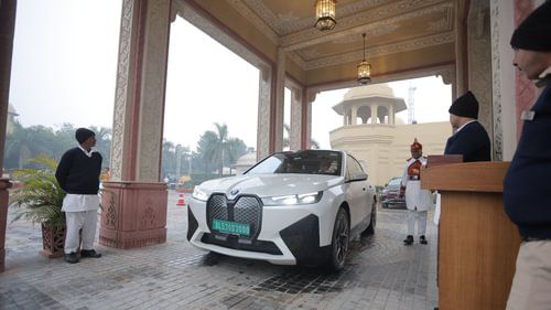 A sleek vehicle is parked in a modern, well-lit space with a polished floor. - Heritage Village Resorts & Spa