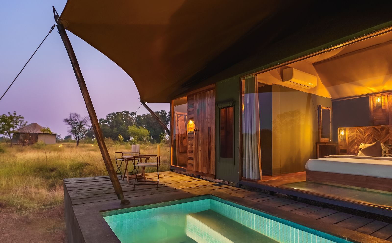 A view from outside of a tent with a plunge pool at Trees N Tigers, Tadoba.