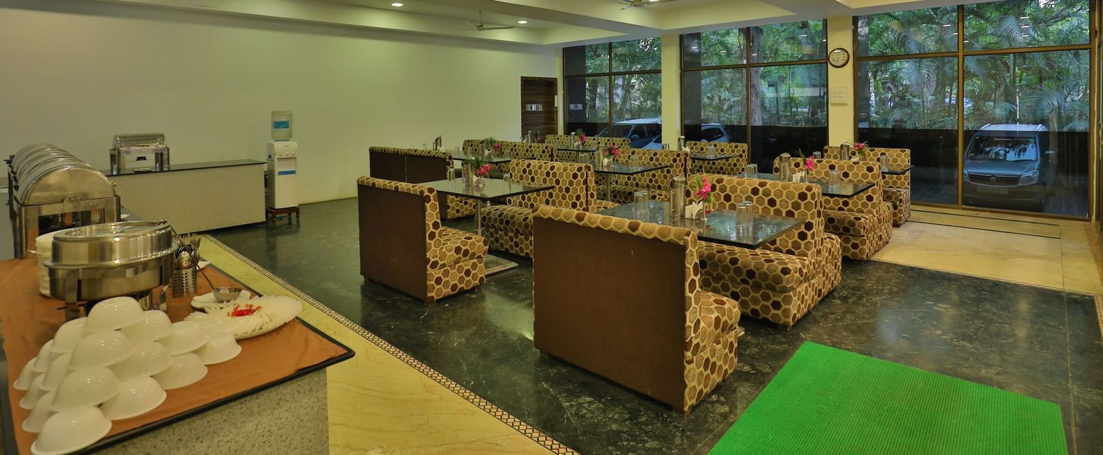 A large dining area with various seating areas, including sofas and low tables, and warm lighting - Retreat Heritage, Lonavala