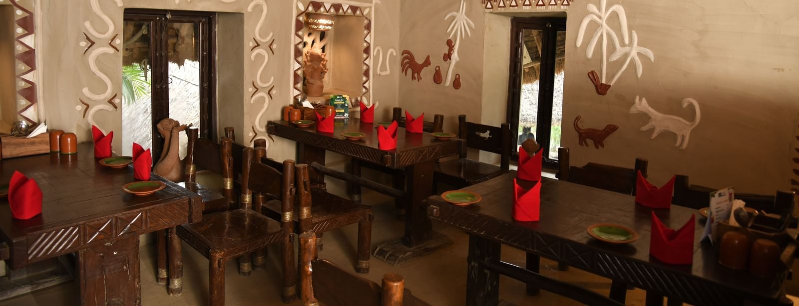 A broader perspective of the restaurant dining area, showcasing multiple tables and the distinctive architecture of the space | Bhoomi Restaurant