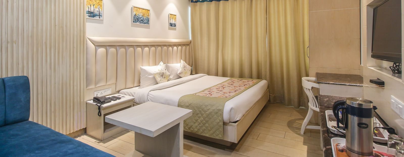 Well-furnished double room with seating area and writing desk at Hotel Diamond Plaza, Chandigarh