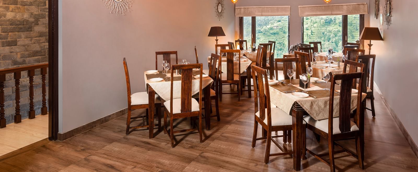 Rustic indoor dining area with wooden furniture and sloped ceiling, at BluSalzz Collection - Suvaasa Resort, Ramgarh.