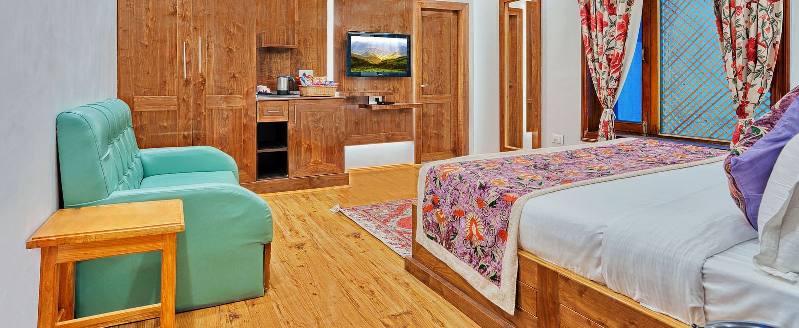 Well-appointed guest room with modern amenities and vibrant decor at Royal Comfort Regency, offering comfort in every detail.