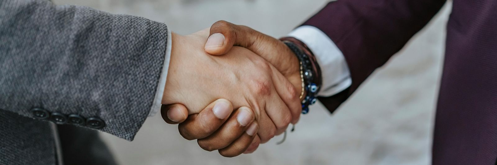 An image of a two men shaking hands with each other