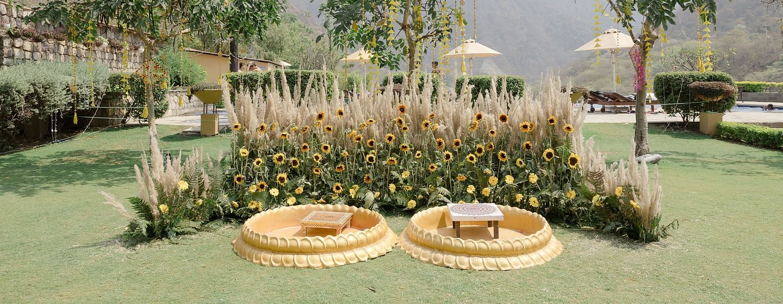 his image showcases a beautiful outdoor venue set against a picturesque backdrop of mountains and greenery. 
