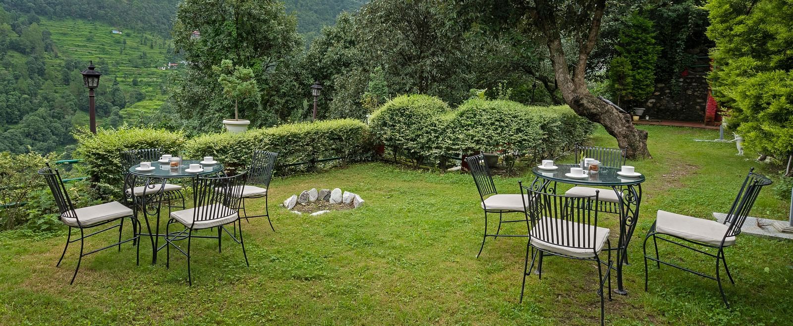Outdoor lawn seating arranged in a circle with mountain views, at BluSalzz Collection - Suvaasa Resort, Ramgarh.