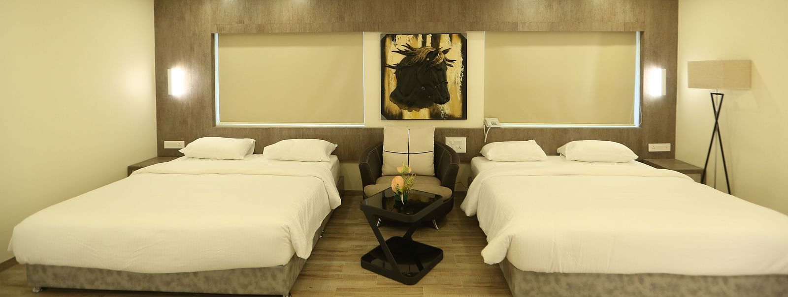 Club Suite with two double beds, and soft lighting.