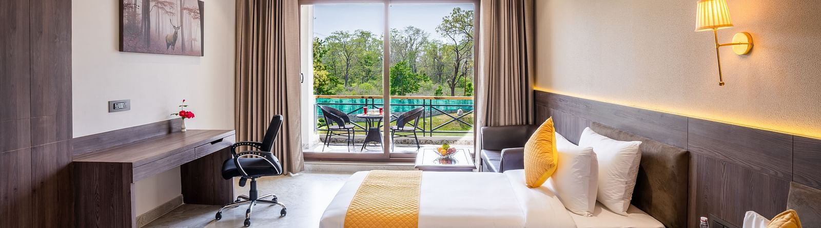A hotel room with twin beds, ambient lighting and a balcony - Shervani Pebbles & Pines, Corbett