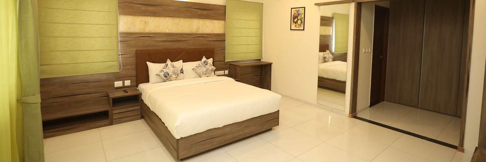 A hotel room with a large bed, ambient lighting and cupboards - Welcome Inn Hotels