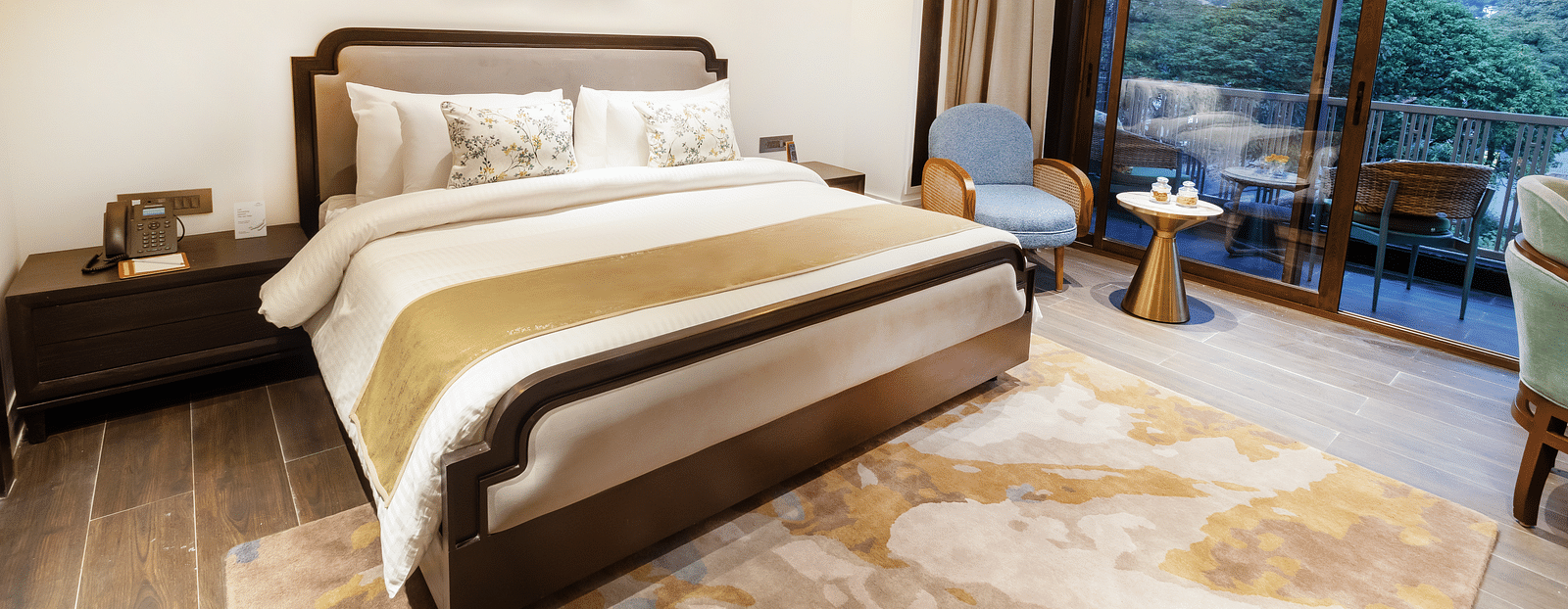 Image of Premium Room with a bed and a photo frame above the wall at Auradoon, Dehradun.