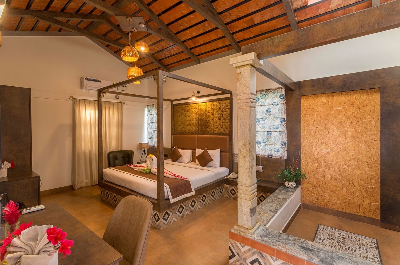 Spacious room with canopy bed and warm lighting at Nirantara Resort