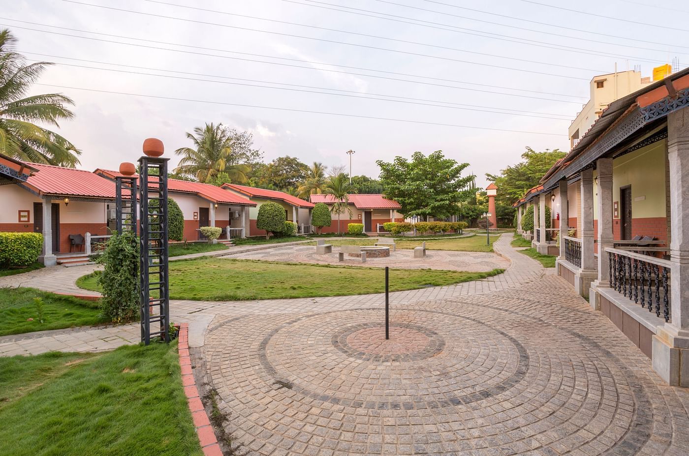Circular paved courtyard with greenery and outdoor space at Nirantara Resort