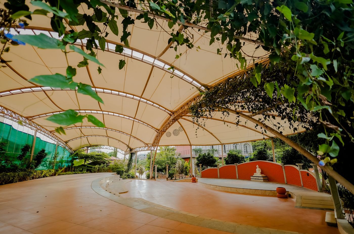 A view of the outdoor event space with the canopy and stage at Nirantara Resort & Spa.