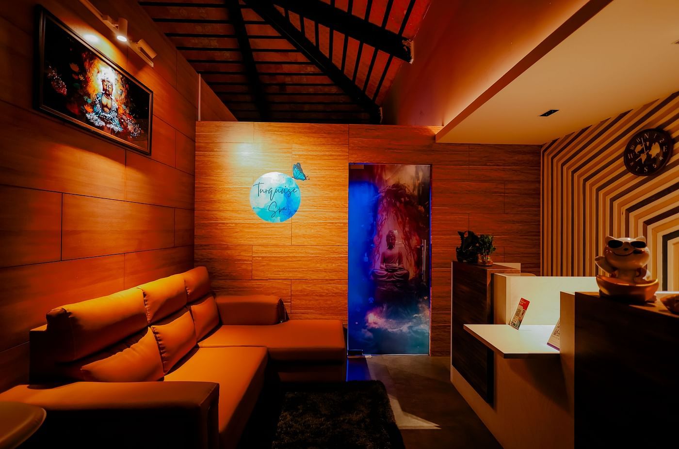 A dimly lit lounge or relaxation area at Nirantara Resort & Spa with comfortable seating and warm lighting.