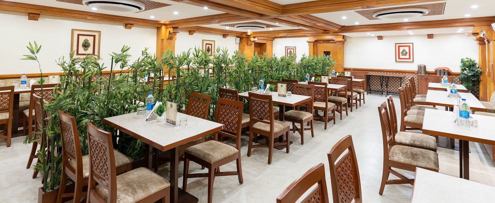 Seating arrangement in restaurant at Hotel Pai Vista, Mysore