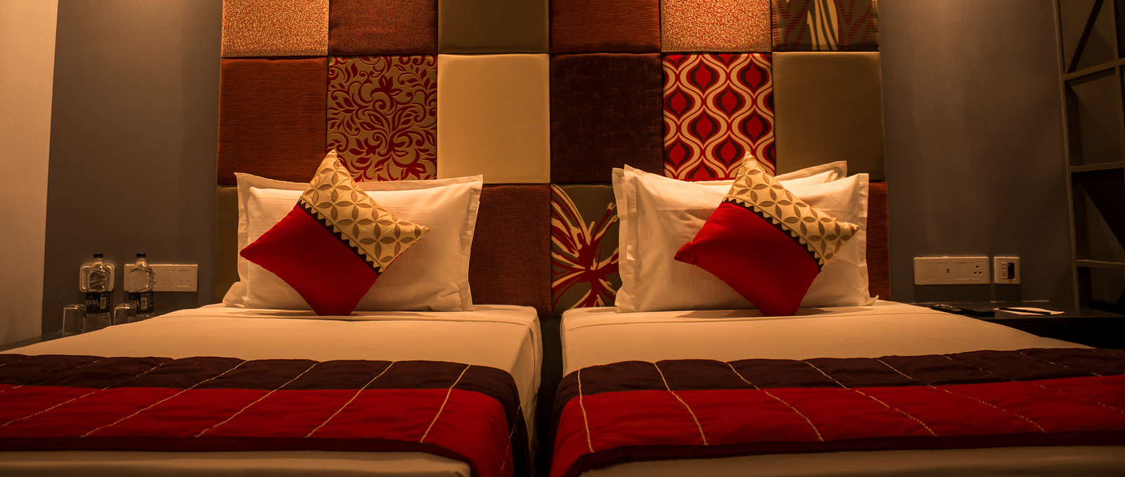 A room with twin beds and  pillows arranged on it  | Regency Tirunelveli By GRT Hotels