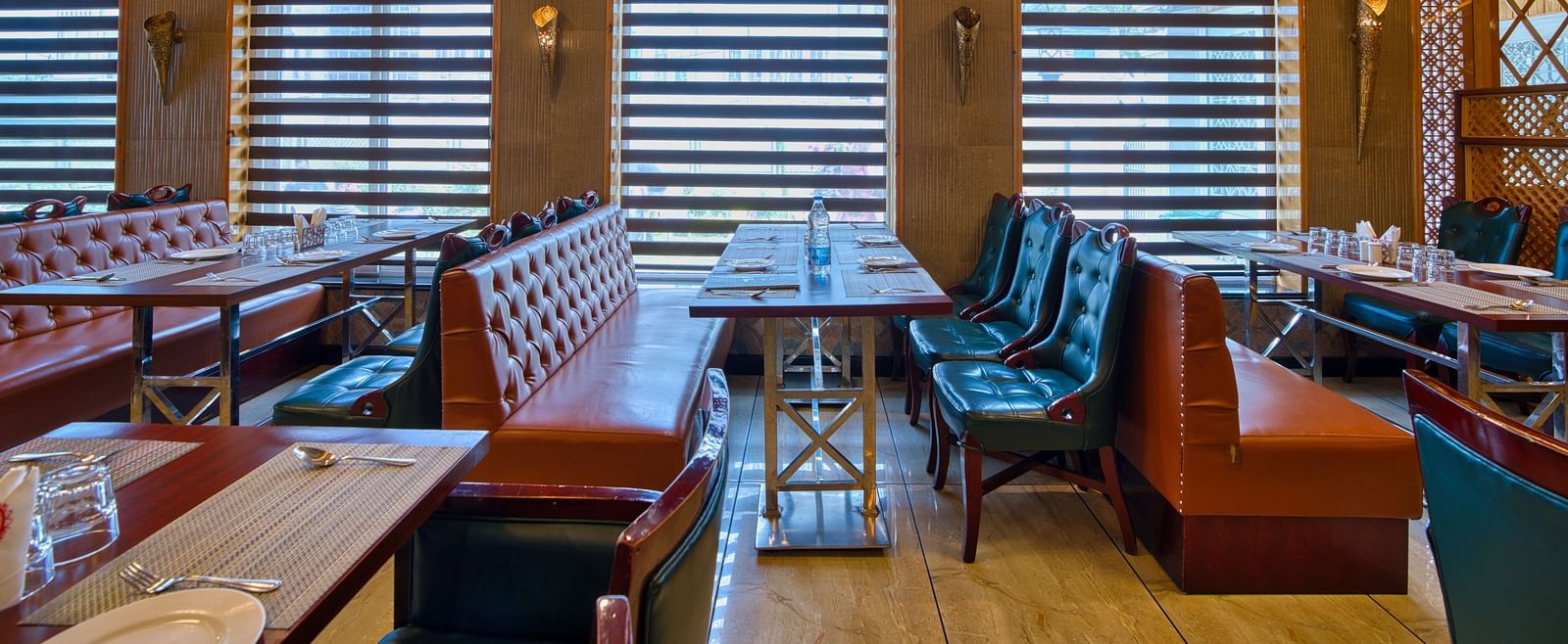 Royal Comfort Regency’s cosy restaurant seating with plush chairs and ambient lighting, perfect for relaxed meals and gatherings.