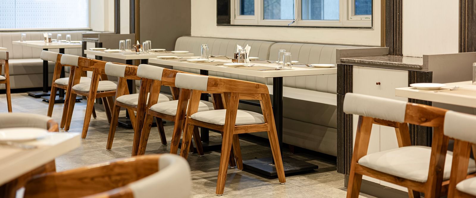 Cosy dining corner with natural light and wooden decor at Lemonridge Hotels, IDPL Balanagar