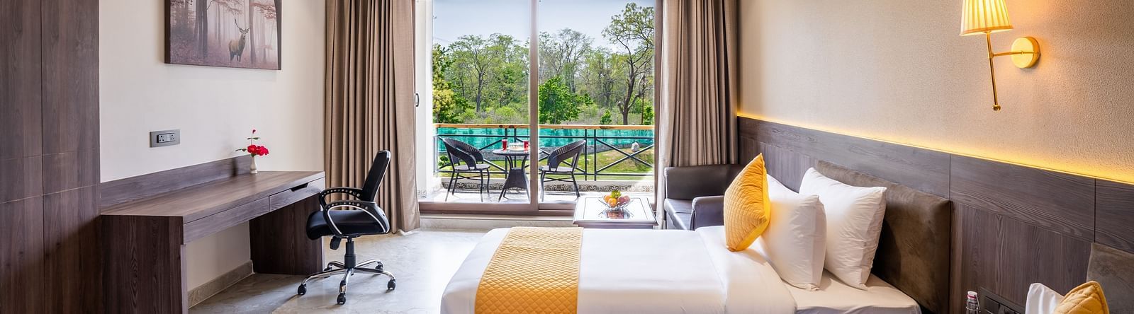 A hotel room with twin beds, ambient lighting and a balcony - Shervani Pebbles & Pines, Corbett