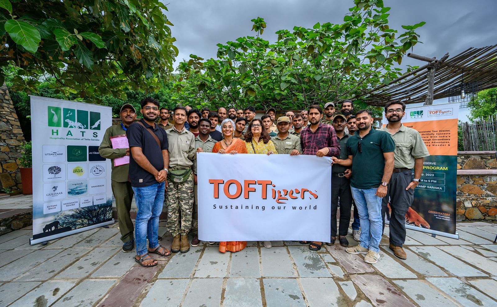 A group of people posing for the camera holding a banner named TOFTTigers - Utsav Camp