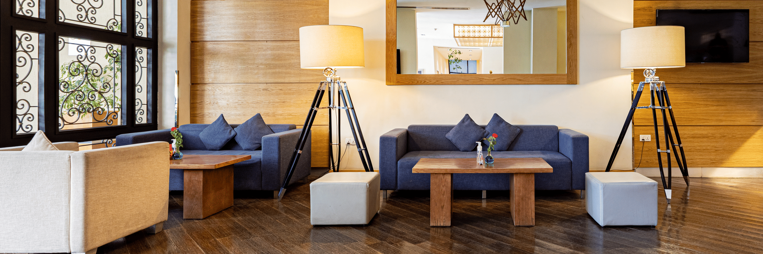 An overview of a Lounge area with blue couch and lamps at Ramada by Wyndham Addis, Addis Ababa