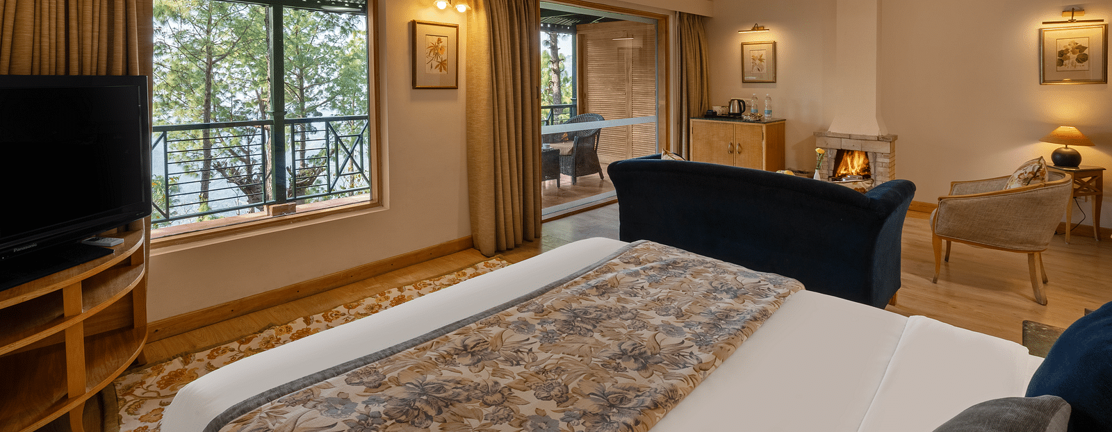 A premium cottage room featuring a cosy bed, open windows, and wall light fixtures that create a warm ambience -  Baikunth resort, kasauli 