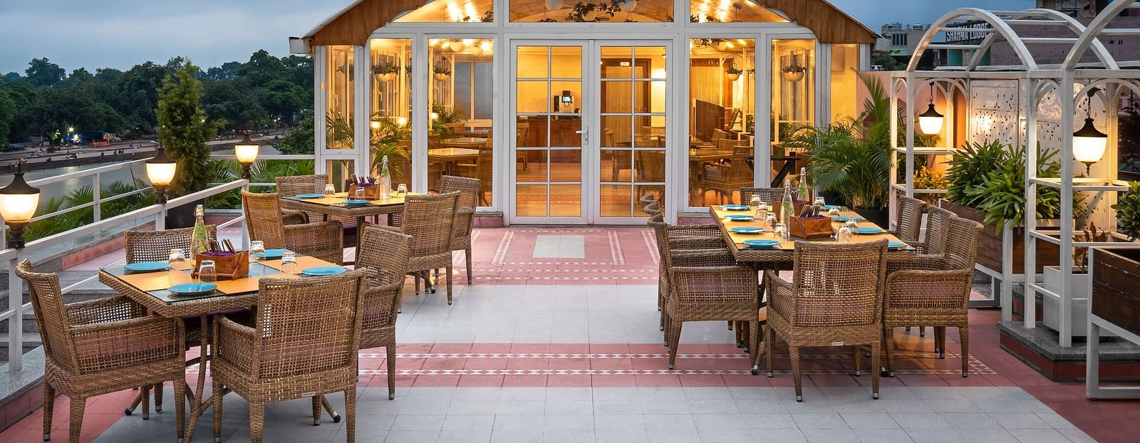 Restaurant Patio with the outdoor dining arrangement with tables and chairs  in clusters - Ganga Lahari, Haridwar