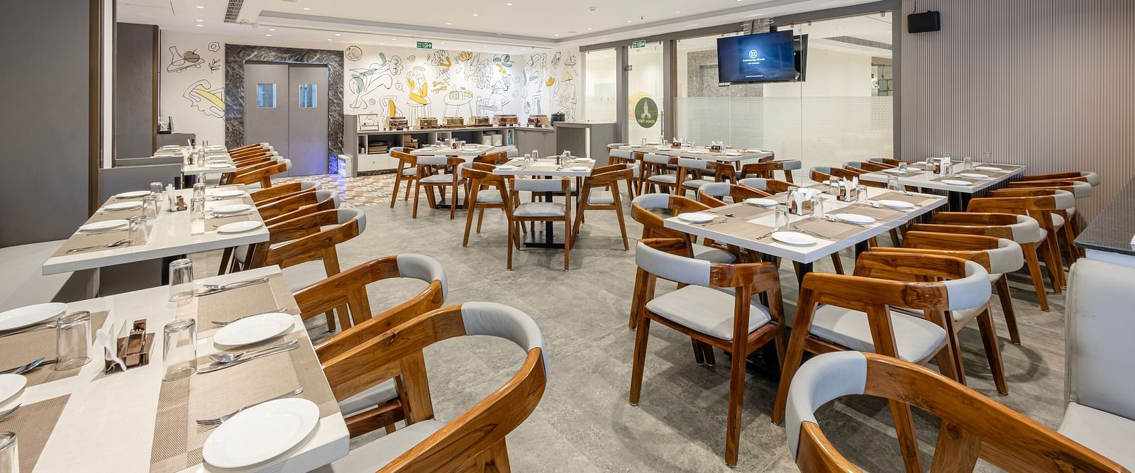 Bright and spacious restaurant seating area at Lemonridge Hotels, IDPL Balanagar