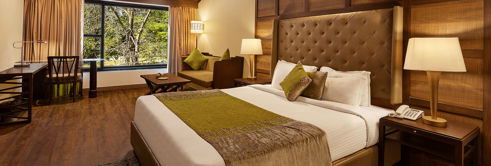 An image of a wooden finished  bedroom with a light hanging from the ceiling at Leisure Hotels.