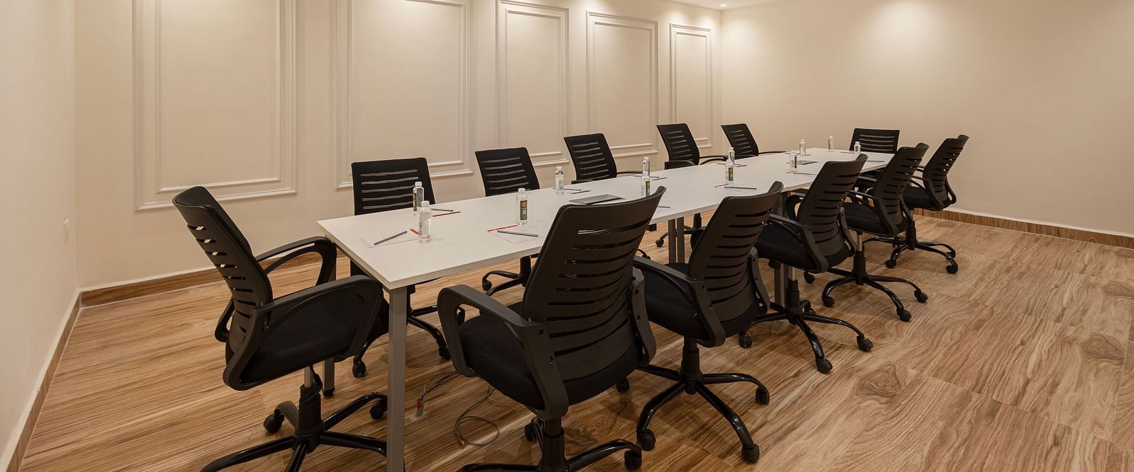 Professional meeting room with ample lighting and seating for corporate discussions at Lemonridge Hotels, IDPL Balanagar.