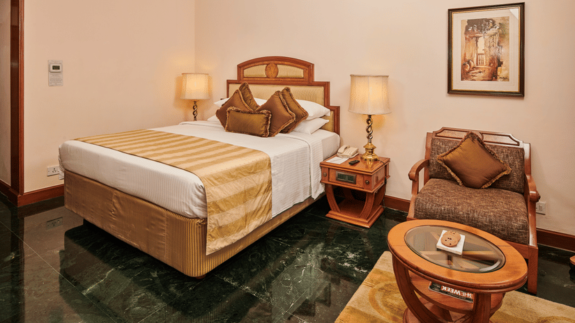 Luxury suite bedroom with king bed at The Ummed Ahmedabad