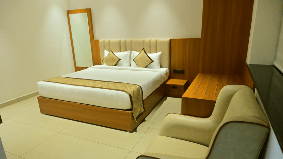 Suite of Bhavanis Vista By Icon featuring a bed, a headboard, and an armchair.